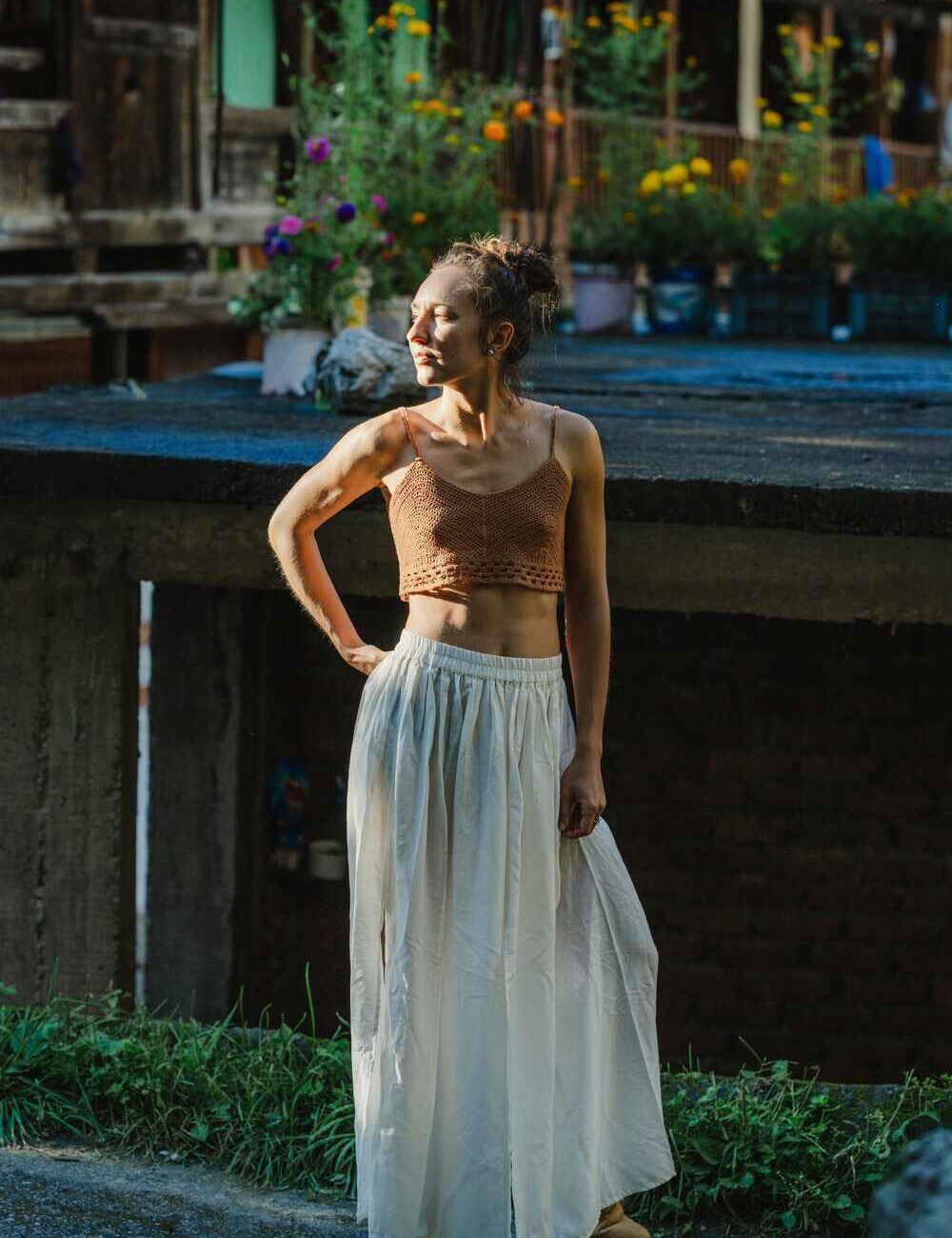 Model showcasing an off-white cotton linen skirt with front cuts.