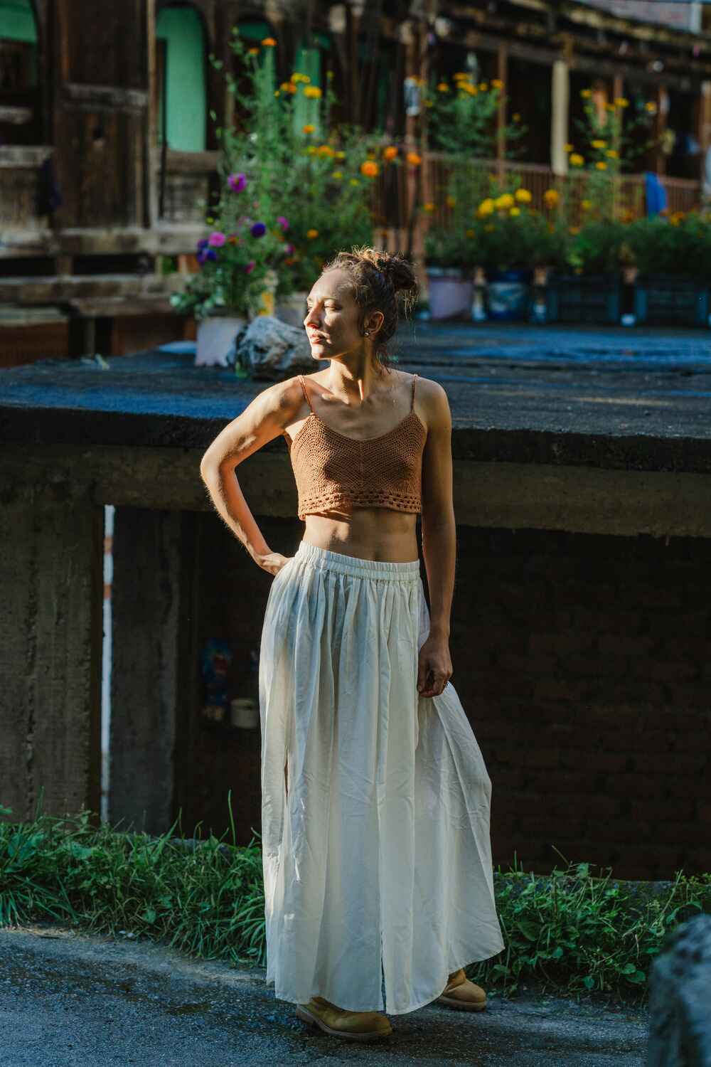 Model showcasing an off-white cotton linen skirt with front cuts.