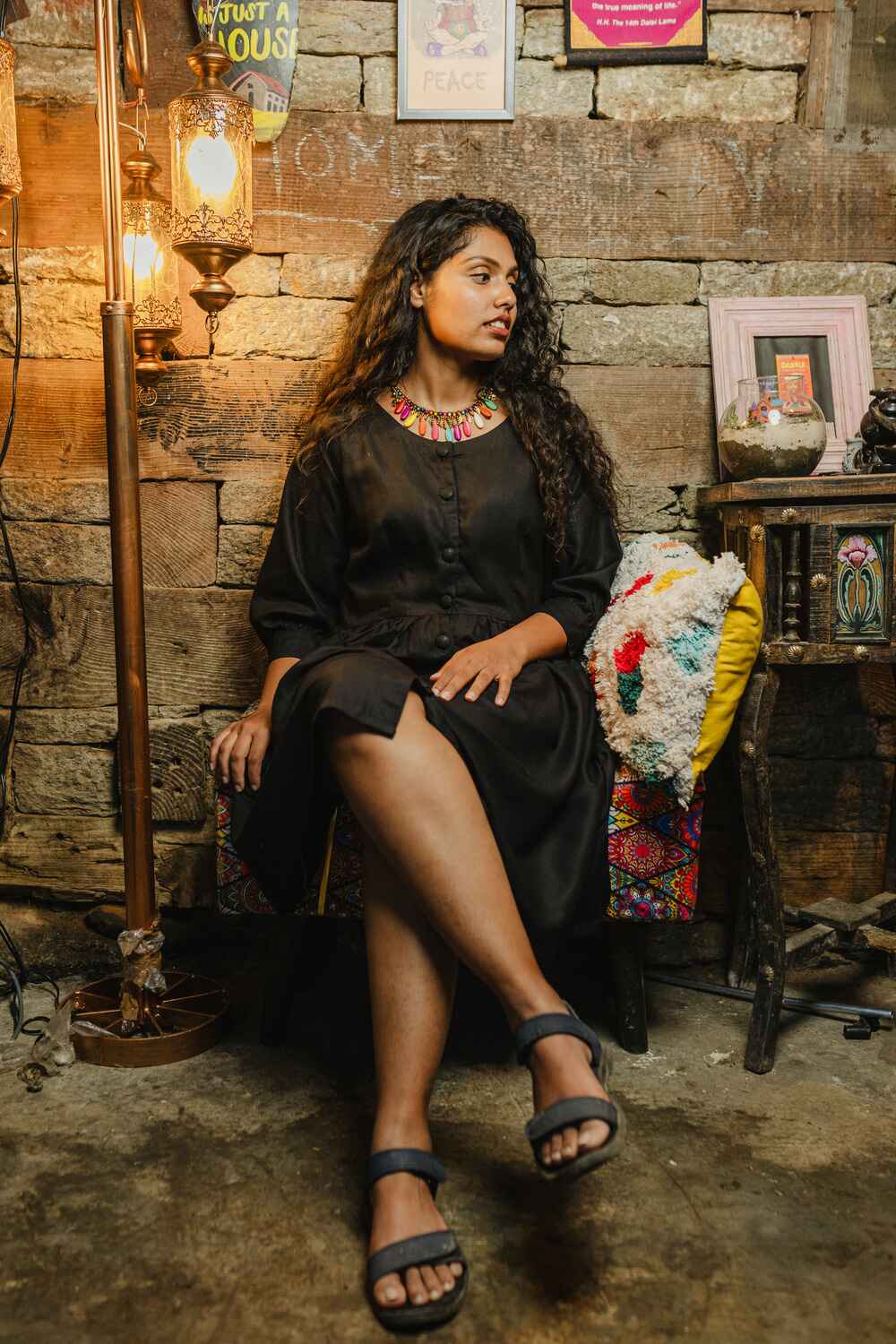 Model in a comfy black linen-cotton short dress for women with three-quarter sleeves, standing outdoors.