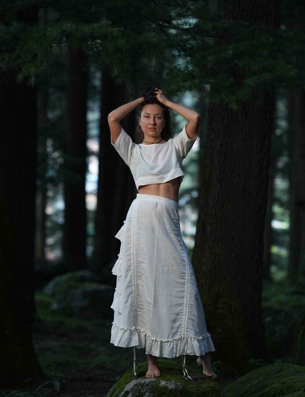 Model wearing a chic white cotton linen crop top with a wrap-around design.