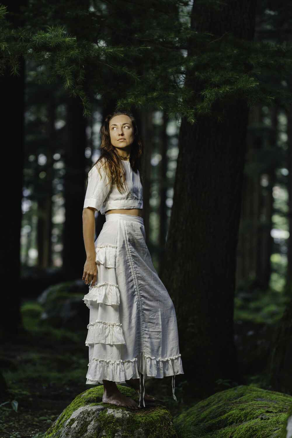 Model wearing a beautiful white cotton linen skirt with ruffles and a flowing design.