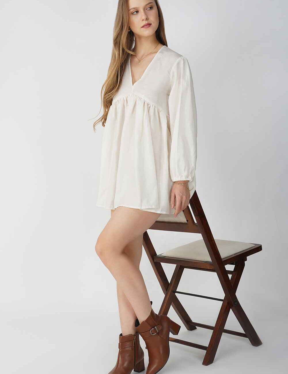 Model wearing a chic off-white linen cotton short dress with a relaxed, everyday style.