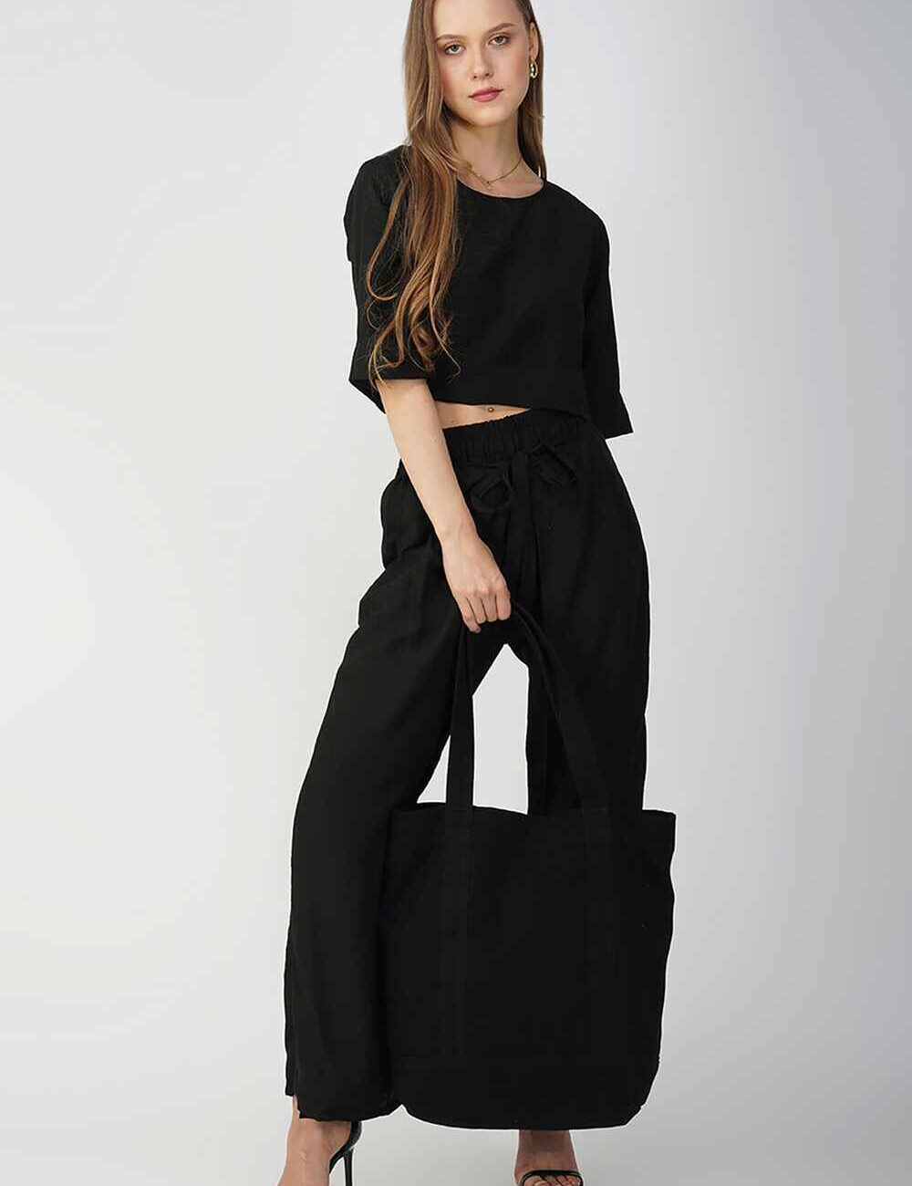 Black cotton-linen palazzo pants with a drawstring waist, providing a relaxed and stylish fit