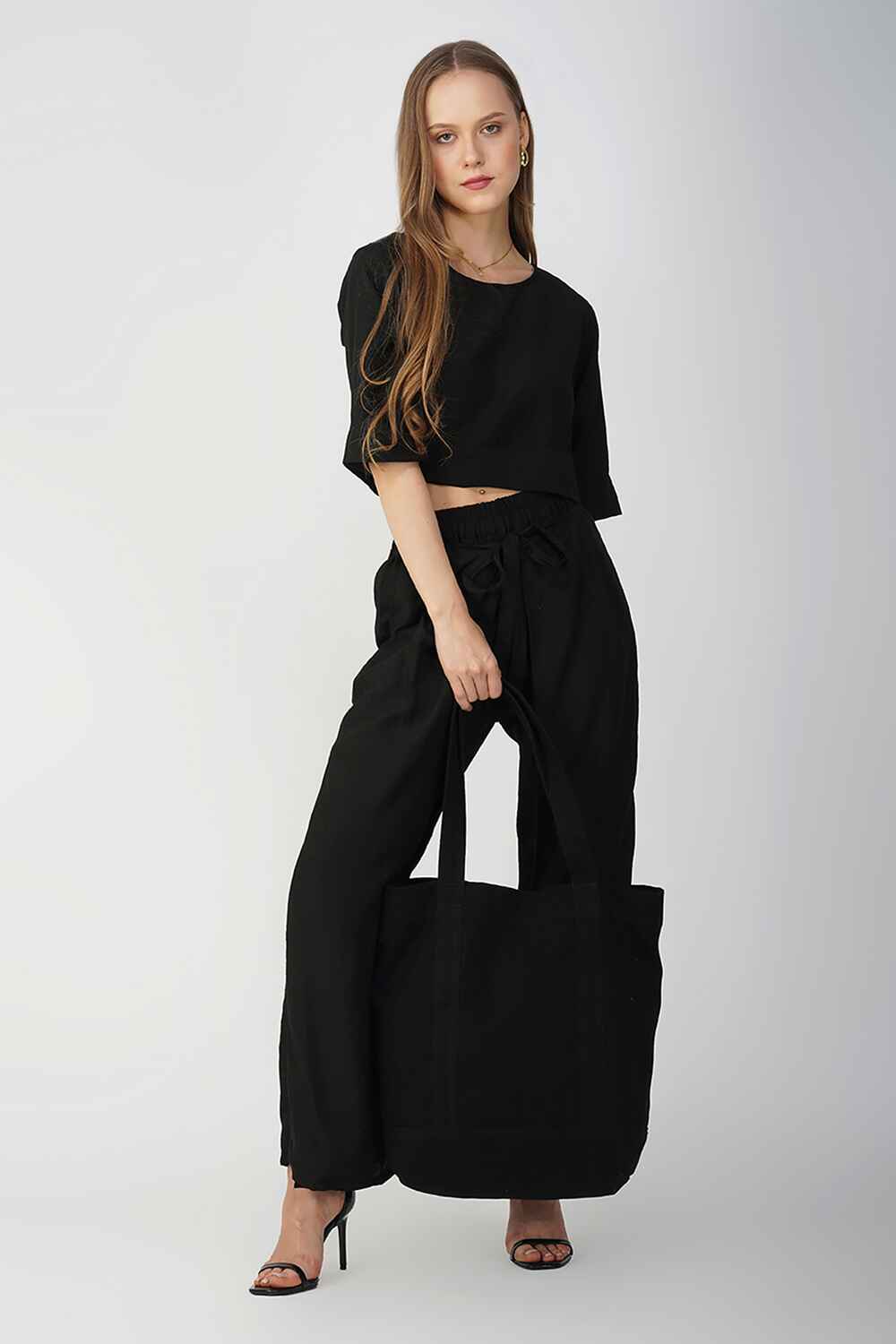 Black cotton-linen palazzo pants with a drawstring waist, providing a relaxed and stylish fit