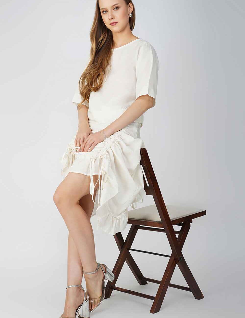 Off-white cotton-linen skirt with ruffled hem offering a versatile and elegant style