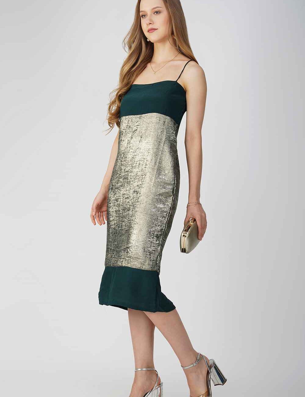 Model wearing a green and gold Zari silk party dress with a fitted shape and spaghetti straps.